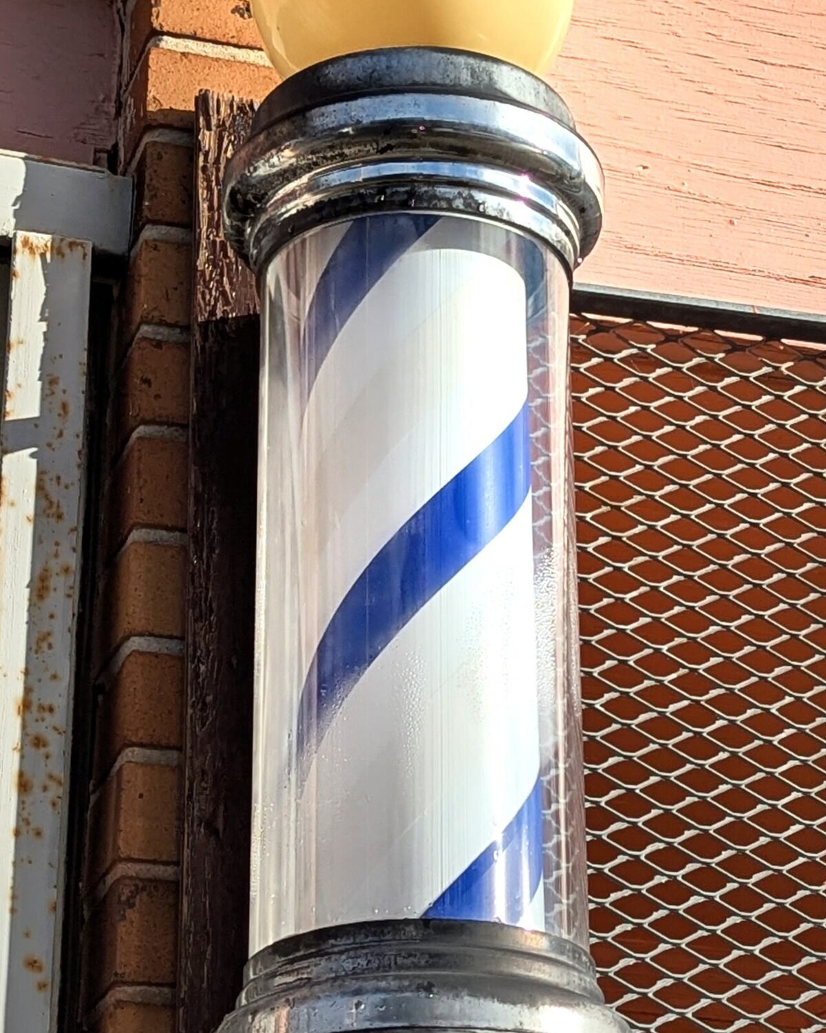 Barber pole mounted outside the shop